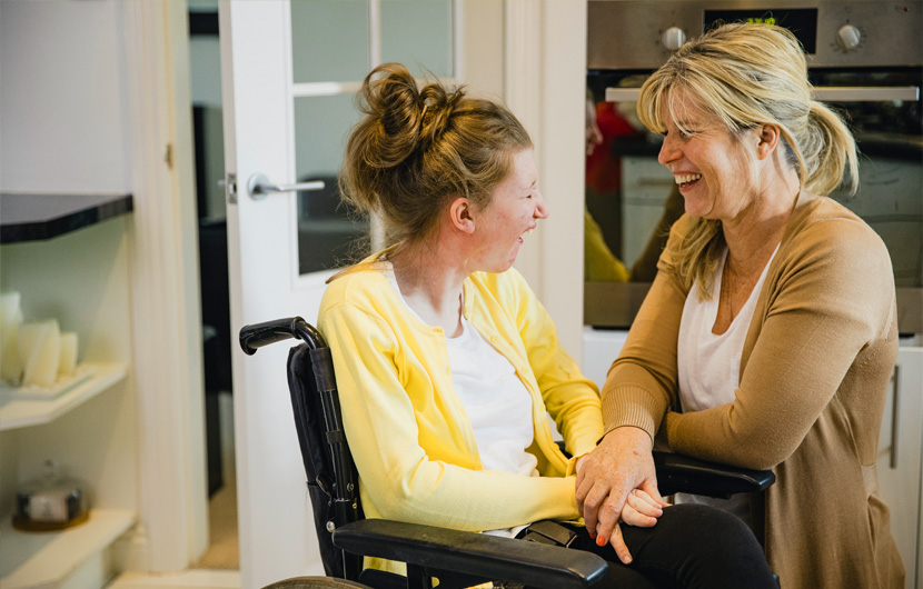 InVision Stock Two Women Wheelchair DSP Inside Laughing