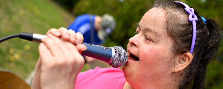 InVision Stock Woman with Down syndrome holding Microphone